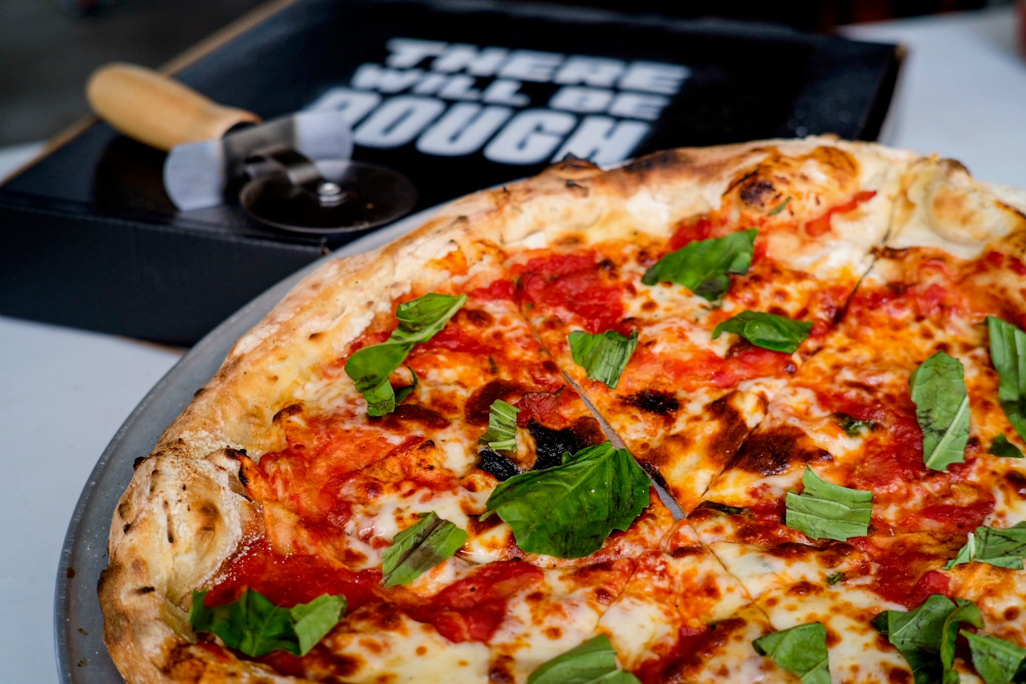Close-up Margherita with the There Will Be Dough box behind it